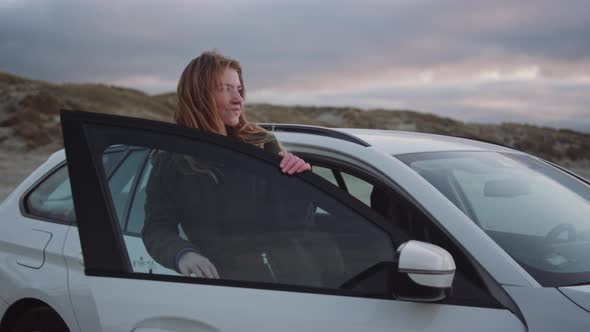 Teenager Getting Out Of Car At Beach
