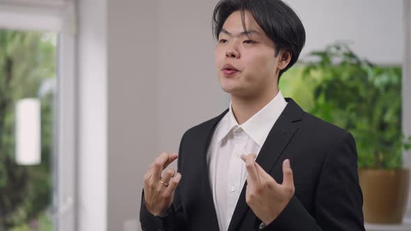 Portrait of Anxious Happy Asian Groom Crossing Fingers Hope Gesture Smiling