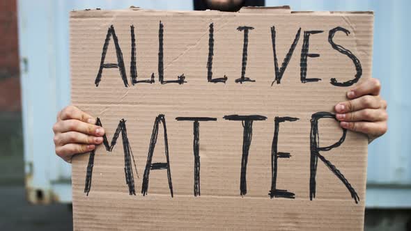 Caucasian Man are Protesting in the Street with Megaphones and Signs