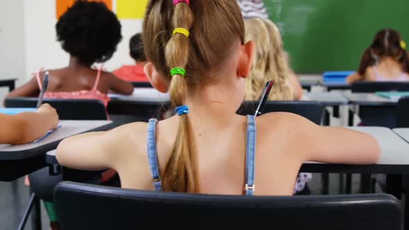 School kids doing homework in classroom