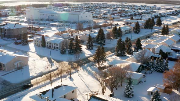 A quiet sunny afternoon in snowy small town streets.