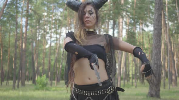 Women Dancers with Bright Makeup and Costumes Standing in Row in Woods, Moving Their Body, Making