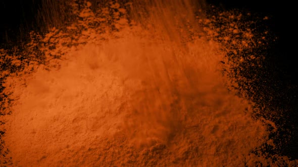 Orange Powder Is Poured Into Pile