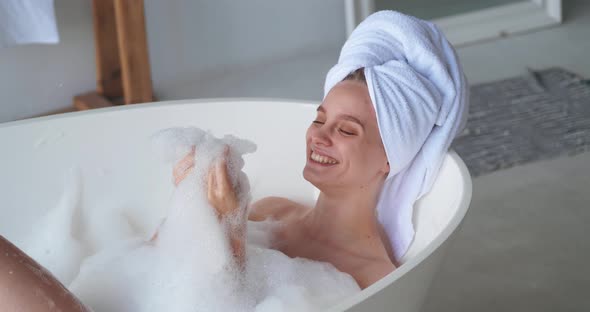 Beautiful Serene Delighted Contented Attractive Woman with White Terry Towel on Her Head Enjoying