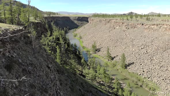 Broken Crumbled Rocks Spilling From the Narrow Canyon Slope Ridge Towards the Deep Valley Floor