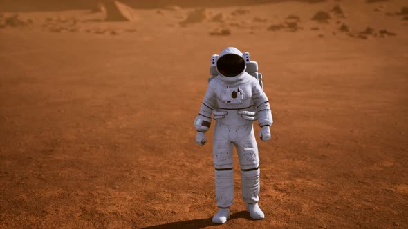 Astronaut on Mars Surface. Red Planet Covered in Gas and Rock