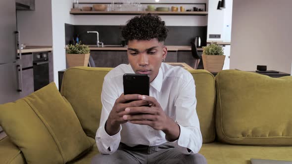 Frustrated Young African Mixed Race Student Feel Stressed Look at Smartphone Screen Worried of