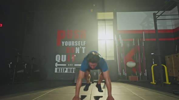 Caucasian young athlete handsome male working out, burpee cardio exercise in fitness gym club.