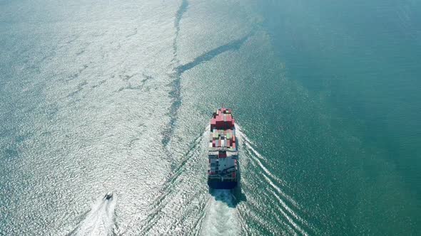 A Cargo Ship Transports Containers Towards Open Ocean Waters