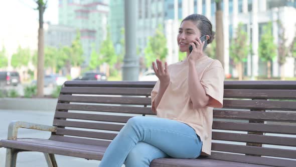 Indian Woman Talking on Phone in Office