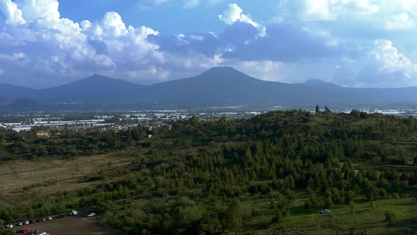 AERIAL: Tangancicuaro City, Mexico, Forest, Clouds, Mountains (Flying Forward)