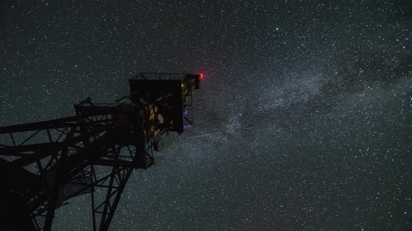 Communication Tower in Starry Night Sky with Milky Way