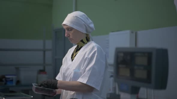 Female Worker in Black Proective Gloves Prepares Fresh Meat for Delivery to Stores