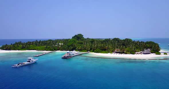 Natural drone travel shot of a white sandy paradise beach and turquoise sea background 