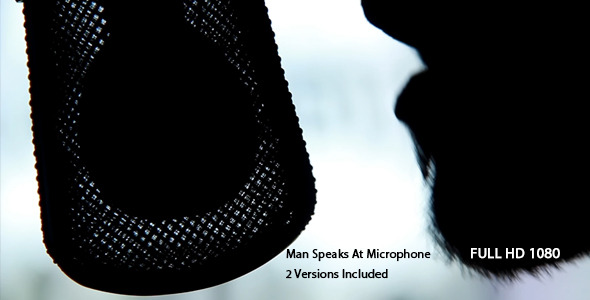Man Speaks At Microphone