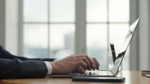 Side View Businessman Working at Laptop in Office Room Closeup