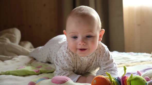 Smiling Child Crawling on Play Mat Playing with Toys in Sunny Bedroom