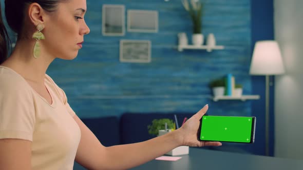 Caucasian Female Holding Isolated Smartphone with Mock Up Green Screen