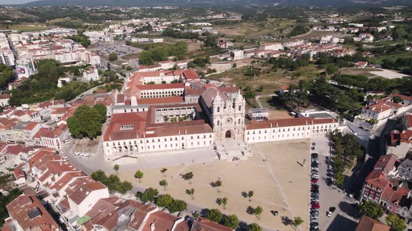 Spectacular aerial pan shot of the front building facade of Alcobaça monastery in central Portugal.