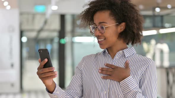 Cheerful African Businesswoman Doing Video Call on Smartphone