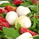 Pour olive oil on Italian salad with mini mozzarella, tomatoes cherry and arugula - VideoHive Item for Sale