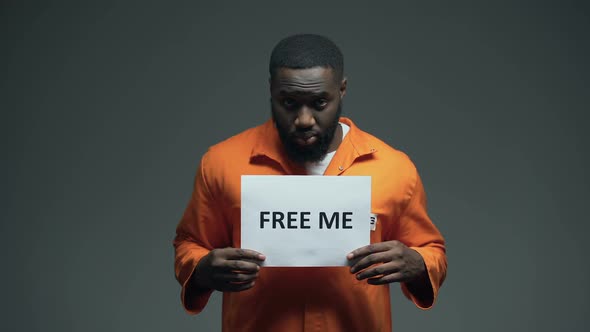 African-American Prisoner Holding Free Me Sign in Cell, Innocent Asking for Help