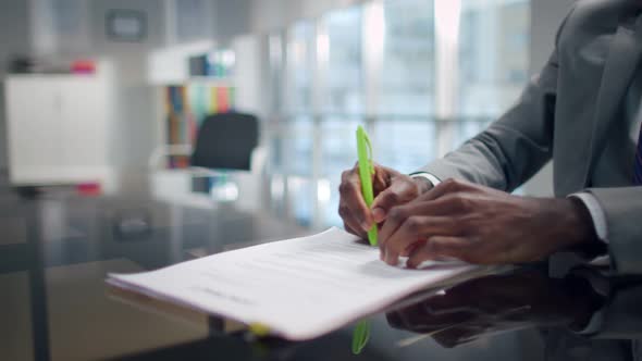 Cropped Shot of AfricanAmerican Man in Suit Sign Contract Over Blurred Background