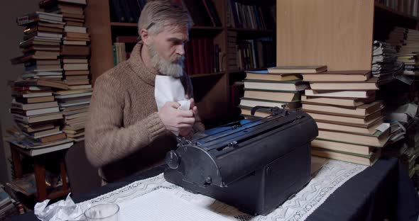 Angry Ernest Hemingway is ripping out a sheet of paper out of the typewriter, 4k