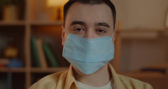 Portrait of Man in Medical Protective Mask Turning Head and Looking To Camera