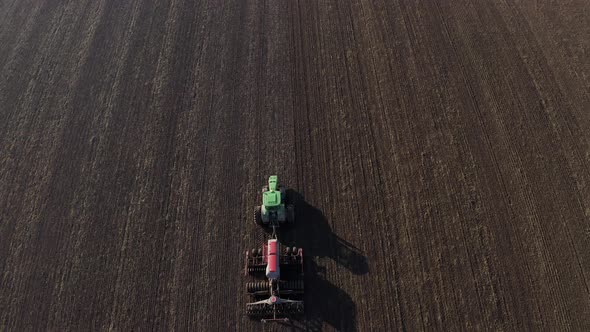 Aerial View Of Harvest Fields. Tractor Driving Across The Field.