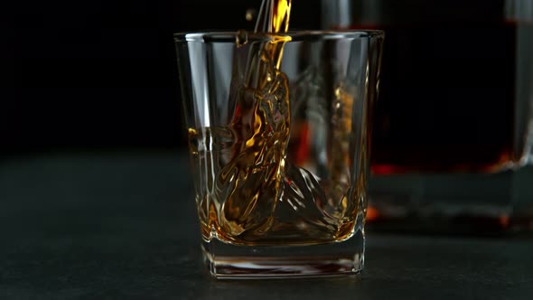 Super Slow Motion Shot of Pouring Whiskey Into Glass at 1000Fps with Camera Movement