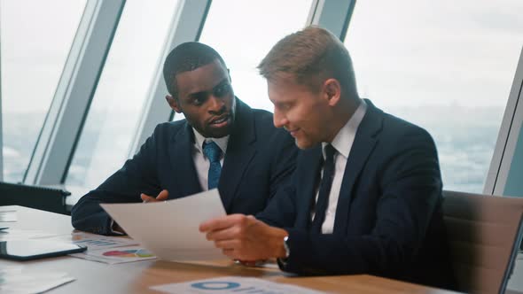 Man leader and businessman in suits discussing project