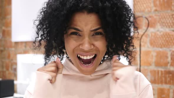 Amazed Happy Young AfroAmerican Woman in Library Surprise