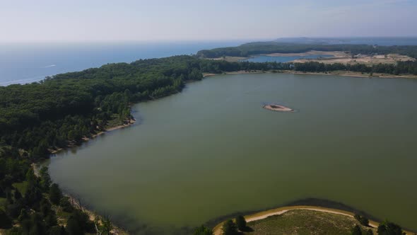 High pan at 300ft over Dune Harbor Lake near Lake Michigan's Coast.