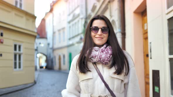 Portrait of Beautiful Elegant Woman in Sunglasses Posing at Historic Building Background