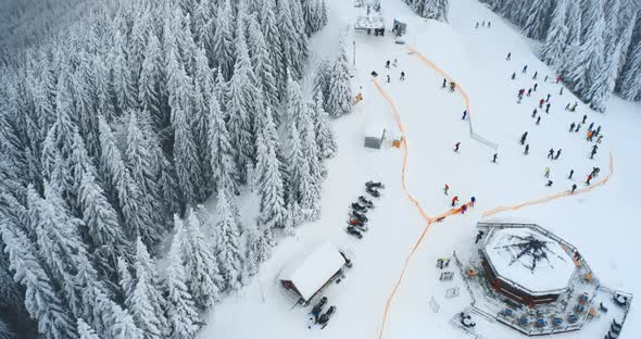 Aerial Skiers in Winter on Snowy Peak Top Slope