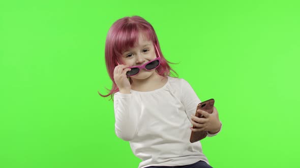 Girl Using Smartphone. Child Emotionally Talking on Mobile Phone, Take Selfie