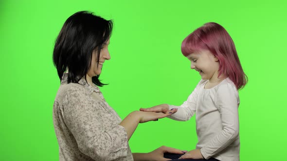 Mother and Little Daughter Playing Rock Paper Scissors. Chroma Key. Leisure Game