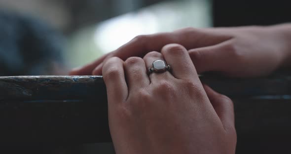 Young woman resting hands on table top close up