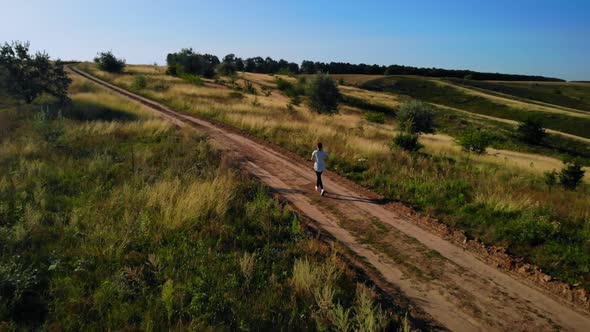 Aerial View on Woman Jogging on Countryside