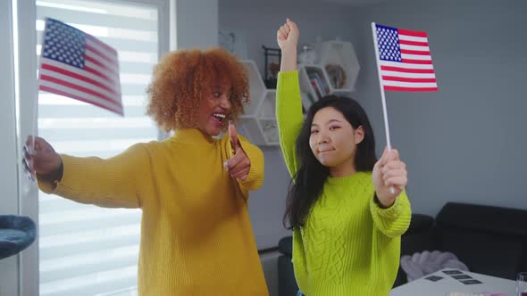 Multiracial Friendship and Student Exchange Program. African American and Asian Woman Holding USA