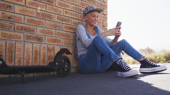 Mixed race woman using smartphone on the street