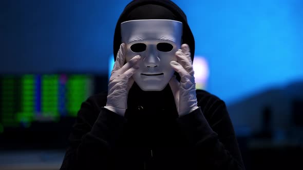 Unrecognizable Man in Black Clothes Holding Anonymous Face Mask