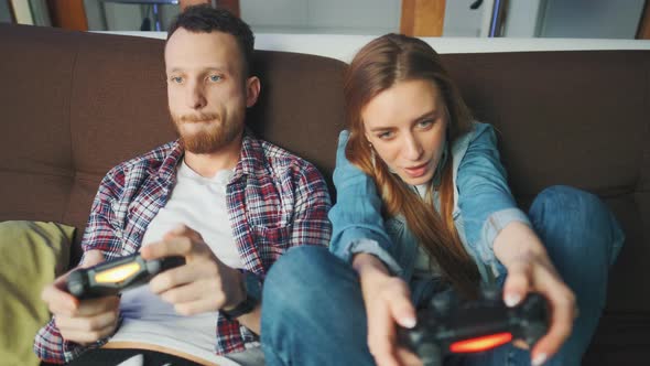 Emotional Diverse Gamers are Holding Joysticks and Competition in Intense Video Game on Gaming