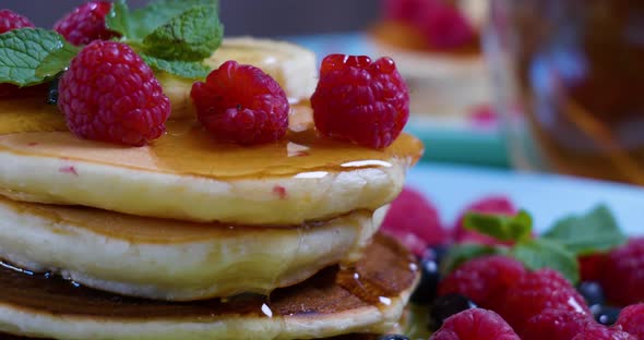 Pouring Honey on Stack of Pancakes