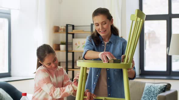 Mother and Daughter Sanding Old Chair with Sponge