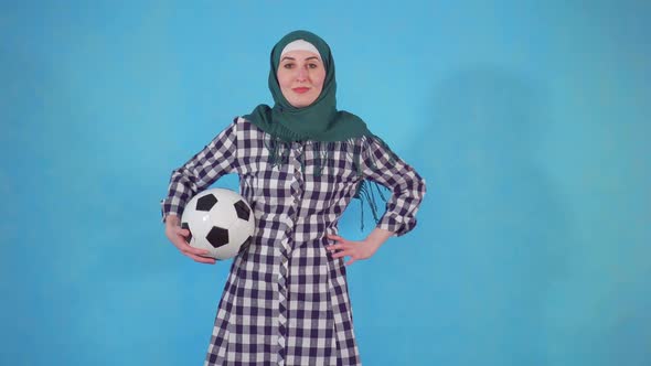Young Muslim Woman in Hijab with Soccer Ball