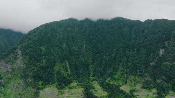 Imposing mountainous landscape of Ponta Delgada, Madeira; drone left