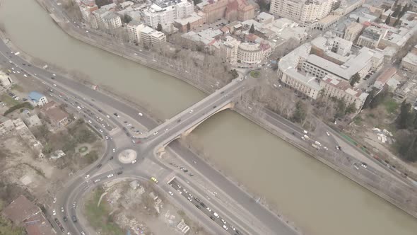 Aerial View of Galaktion Tabidze Bridge over Kura river in the centre of Tbilisi. Georgia 2021 April