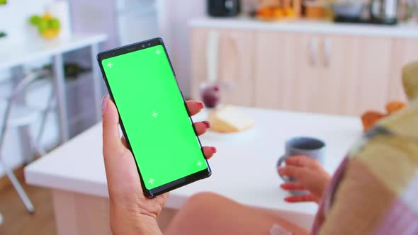 Woman Holding Portable Phone with Green Screen